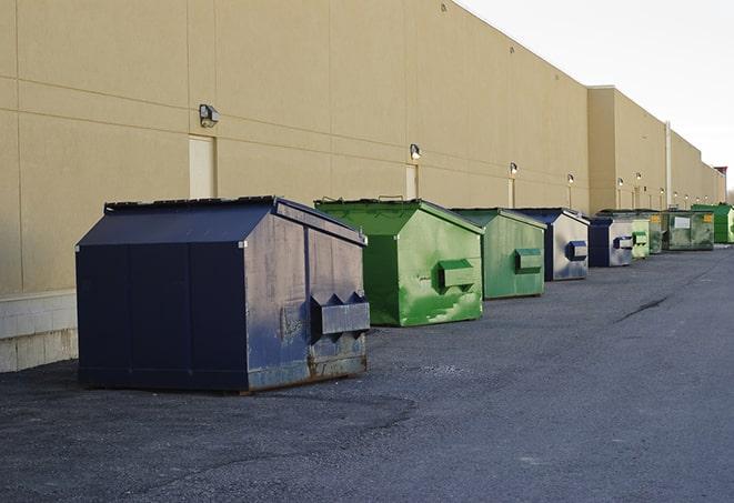 large construction dumpster positioned on a city street in Augusta, KS